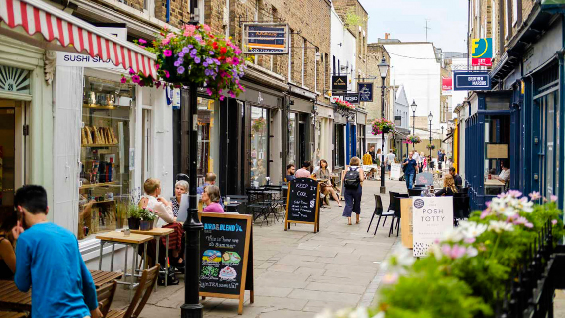 Camden Passage lined with cafés, flower baskets and market stalls