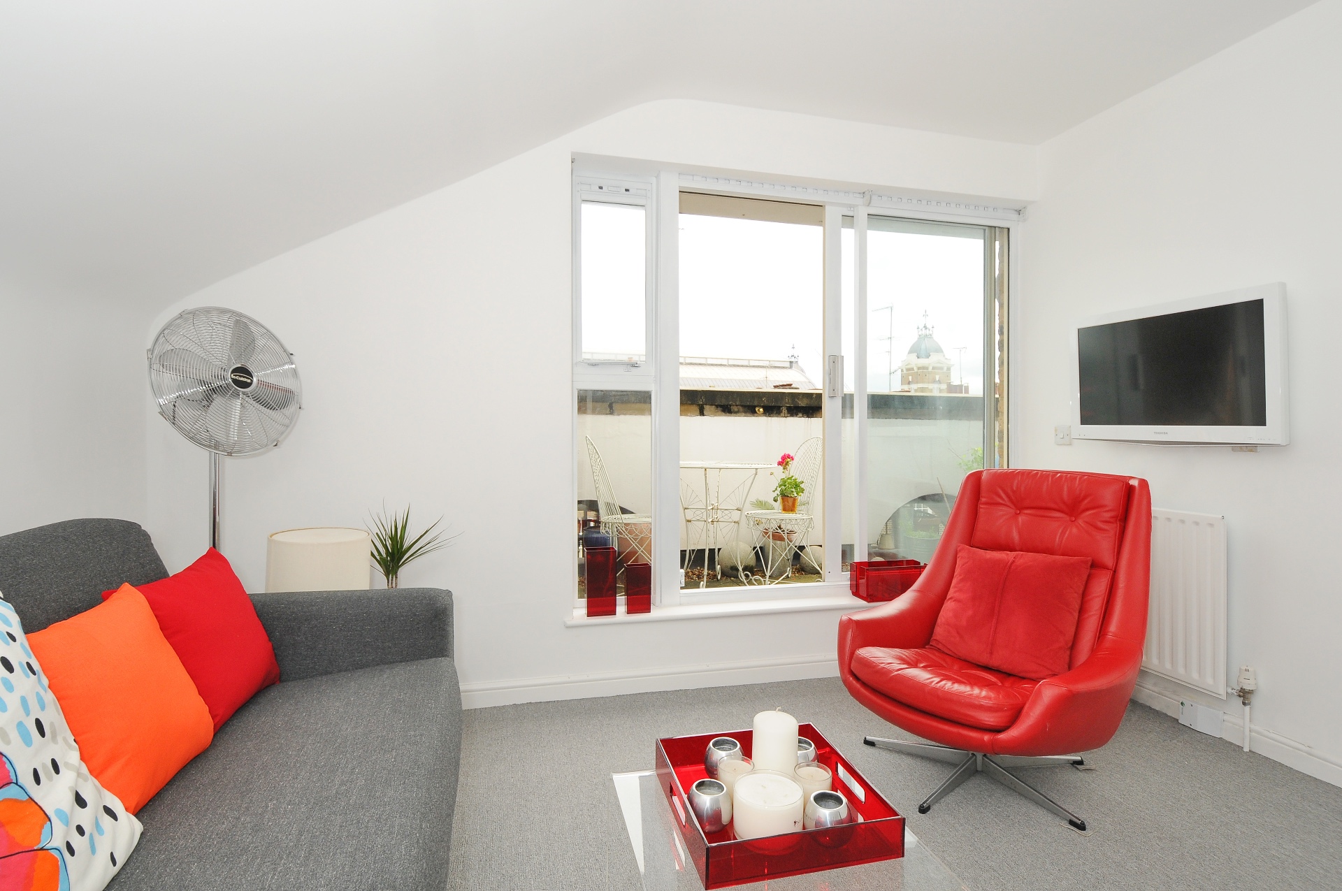 Islington Apartment living room with red armchair