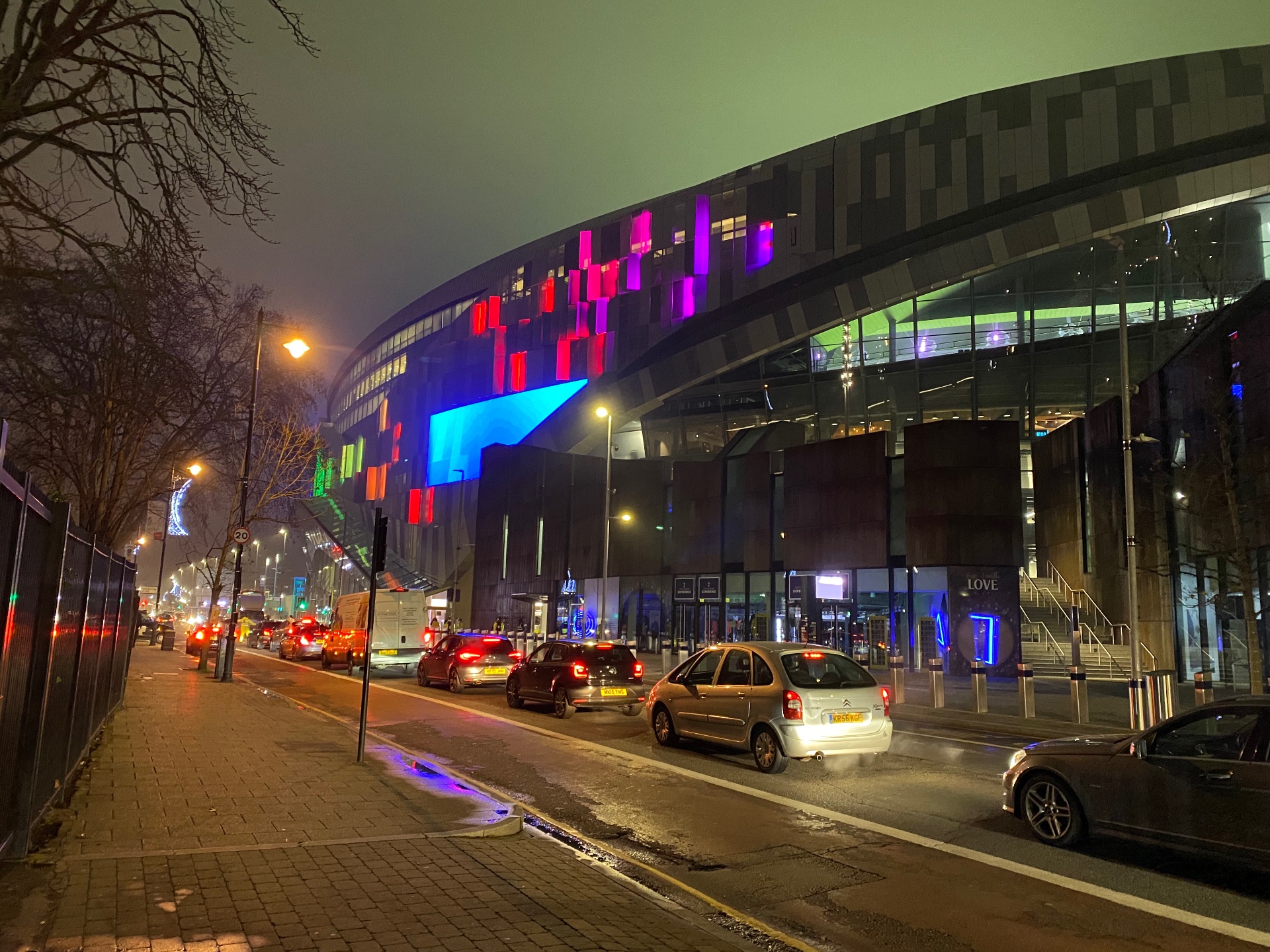 Tottenham Hotspur Stadium lit up in colour at night